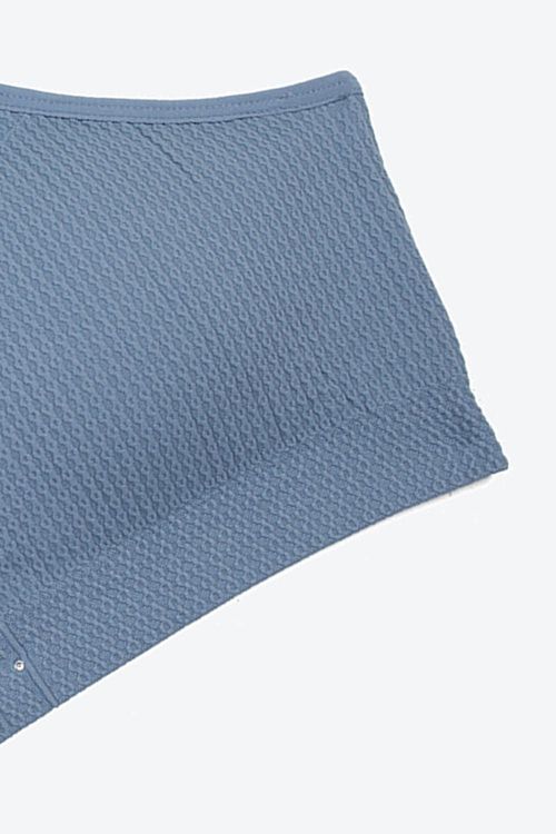 Top x2 tipo seamless con tirantes cruzados y textura espiga